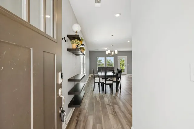 a dining room with furniture and wooden floor