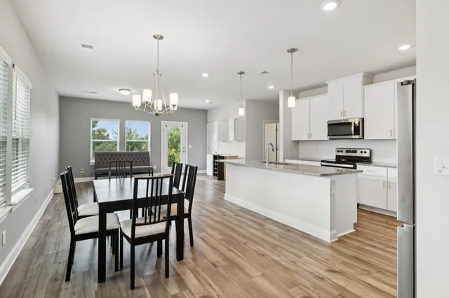 a view of a dining room with furniture window and wooden floor