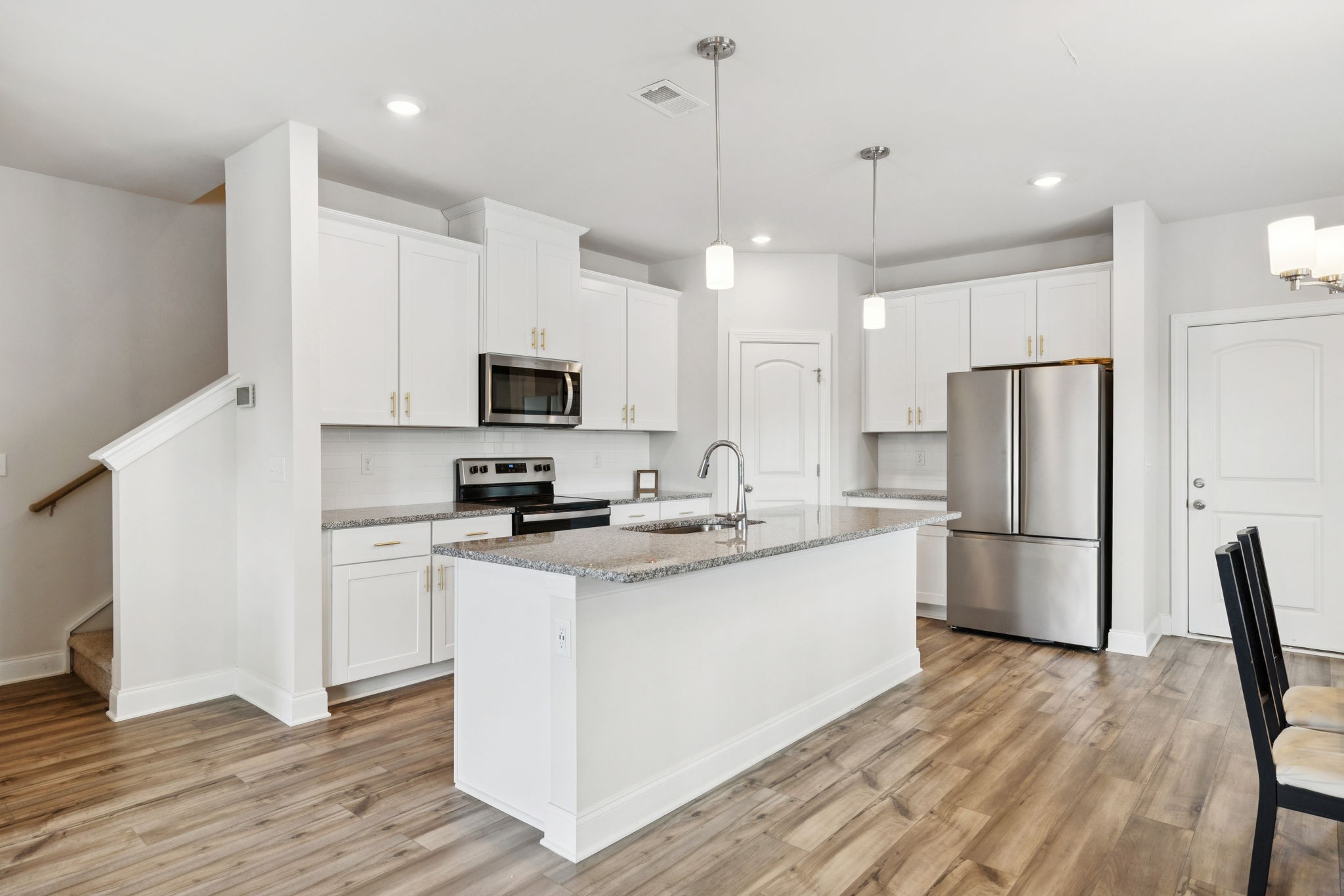 862 Longleaf Lane Columbia, TN 38401 - Photo 34 of 35 a kitchen with a sink a microwave a refrigerator and white cabinets