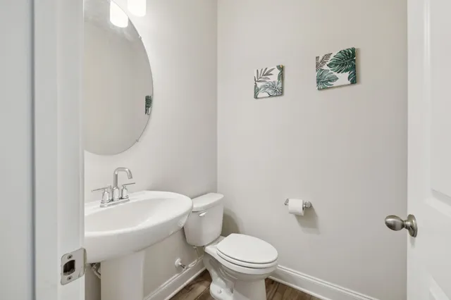 a bathroom with a sink mirror and toilet