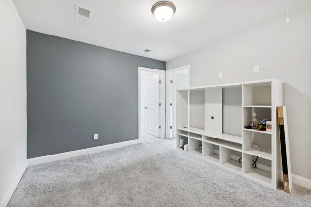 a view of empty room with wooden shelves