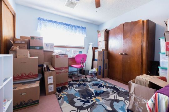 348 South Locust Street Ridgecrest, CA 93555 - Photo 11 of 21 a bedroom with a bed and a mirror