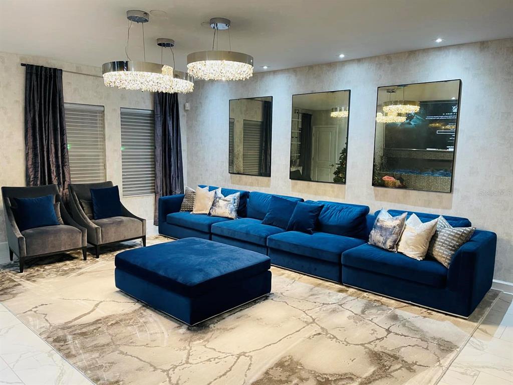 711 North Rome Avenue Tampa, FL 33606 - Photo 2 of 17 a living room with furniture and a chandelier