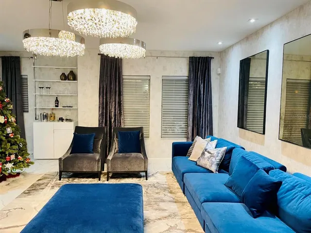 a living room with furniture and a chandelier