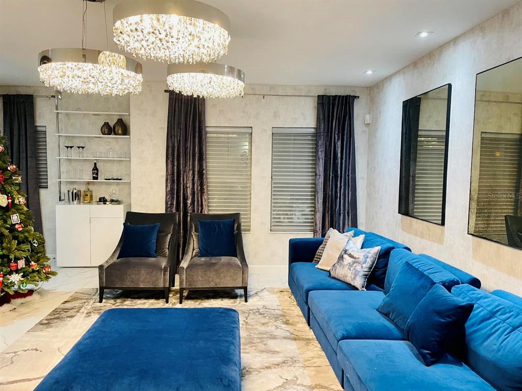 711 North Rome Avenue Tampa, FL 33606 - Photo 3 of 17 a living room with furniture and a chandelier