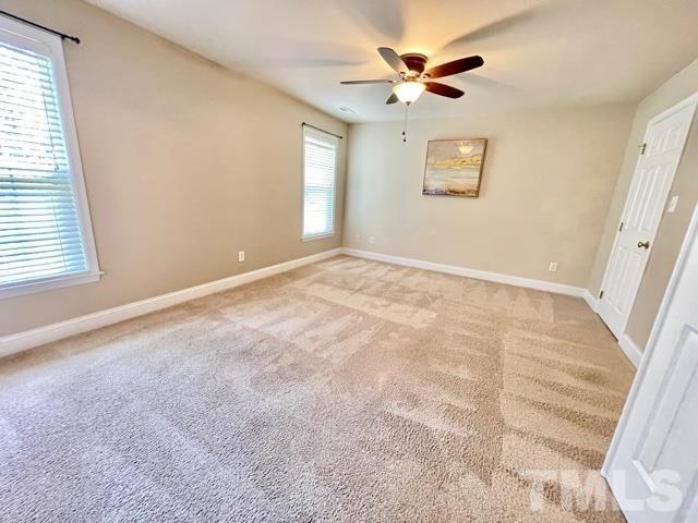 11239 11239th Raleigh, NC 27617 - Photo 12 of 26 an empty room with windows and fan