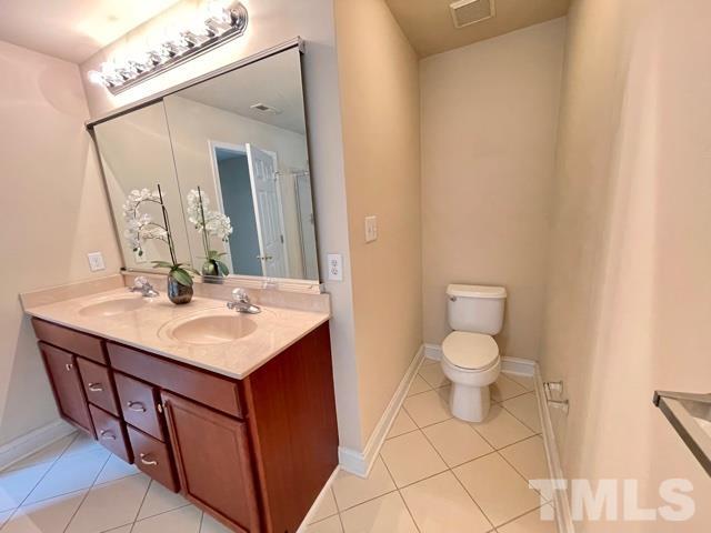 11239 11239th Raleigh, NC 27617 - Photo 16 of 26 a bathroom with a sink vanity and a mirror