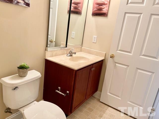 11239 11239th Raleigh, NC 27617 - Photo 22 of 26 a bathroom with a toilet a sink and a mirror