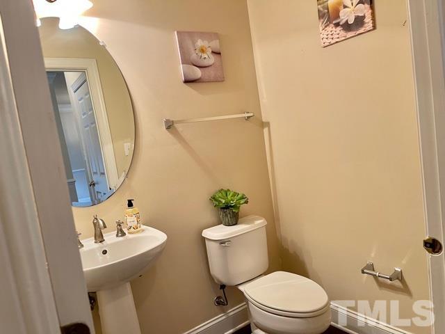 11239 11239th Raleigh, NC 27617 - Photo 5 of 26 a white toilet sitting next to a bathroom sink