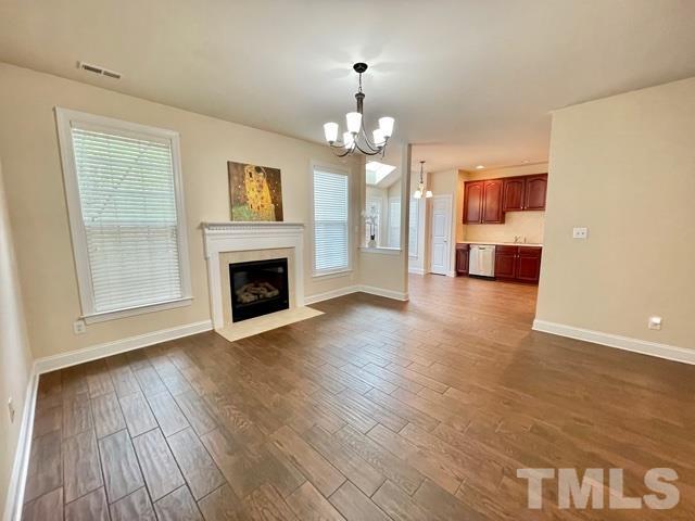 11239 11239th Raleigh, NC 27617 - Photo 6 of 26 an empty room with wooden floor fireplace and windows