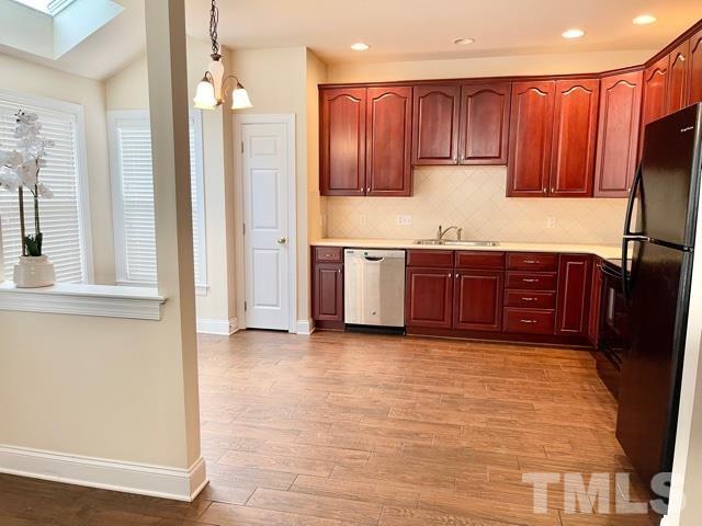 11239 11239th Raleigh, NC 27617 - Photo 8 of 26 a kitchen with stainless steel appliances granite countertop a refrigerator and a sink