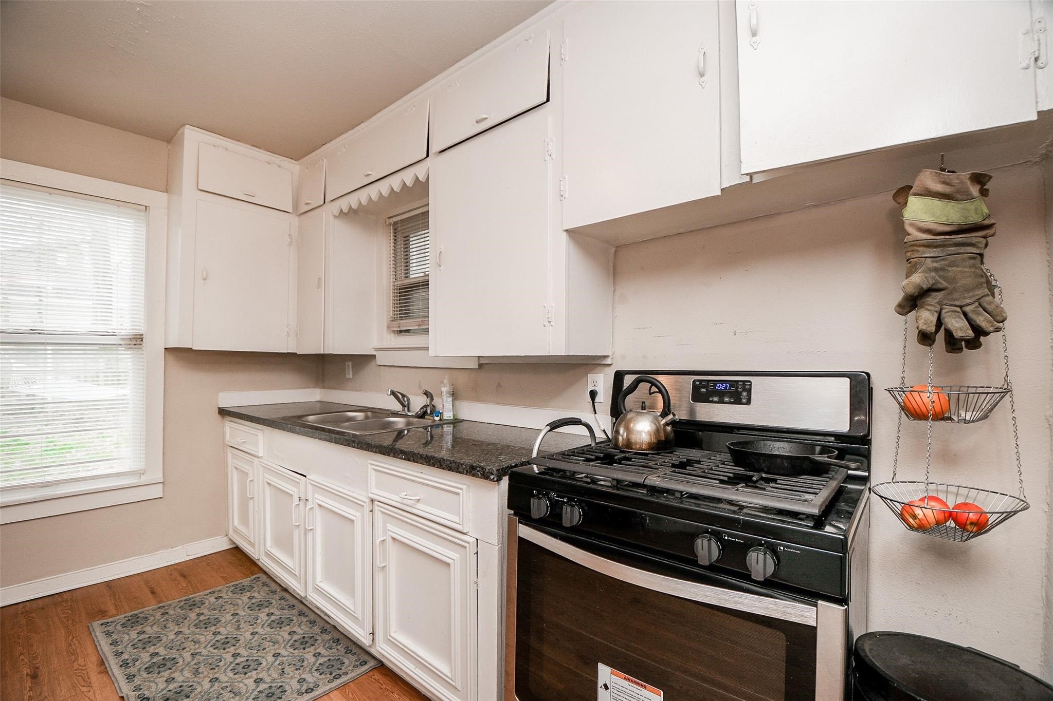 5221 Darling Street Houston, TX 77007 - Photo 11 of 22 a kitchen with stainless steel appliances granite countertop a sink stove and cabinets