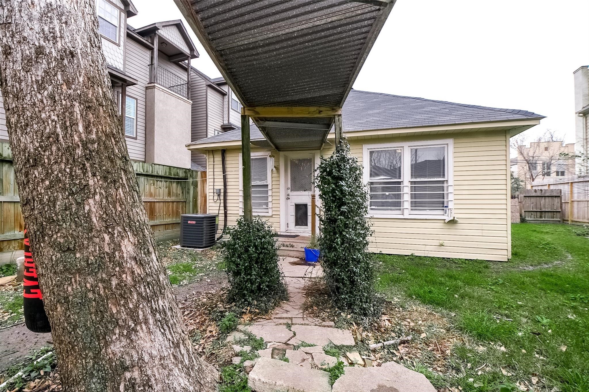 5221 Darling Street Houston, TX 77007 - Photo 14 of 22 a view of a house with a small yard plants and large tree