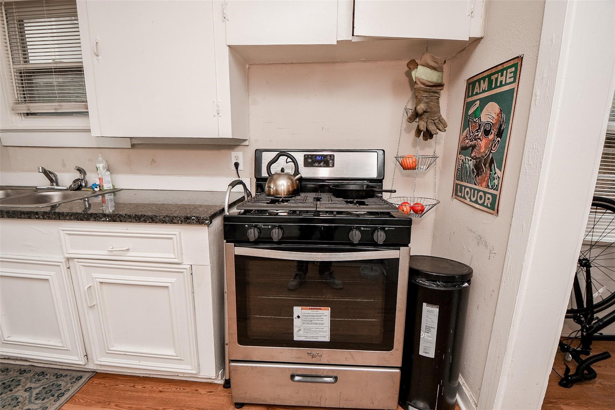 5221 Darling Street Houston, TX 77007 - Photo 19 of 22 a kitchen with stainless steel appliances granite countertop a stove and a microwave