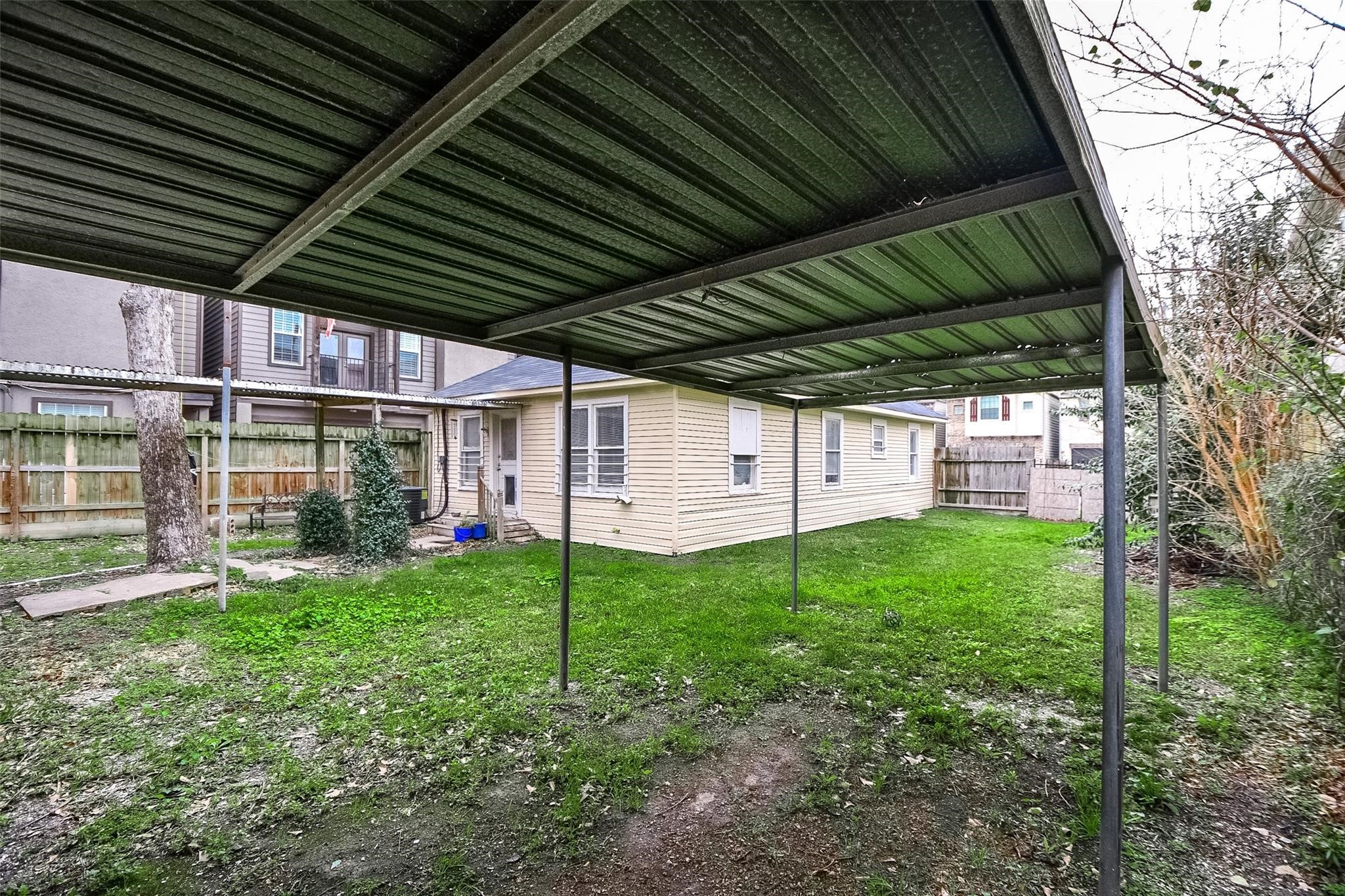 5221 Darling Street Houston, TX 77007 - Photo 21 of 22 a view of a backyard with plants and a patio