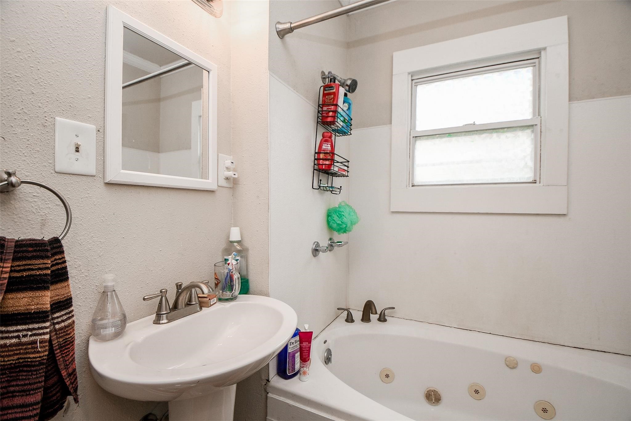5221 Darling Street Houston, TX 77007 - Photo 8 of 22 a bathroom with a sink a bathtub and a window