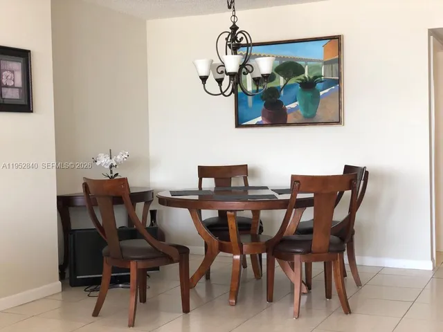a view of a dining room with furniture and chandelier