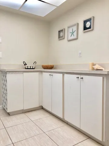 a view of a kitchen with white cabinets