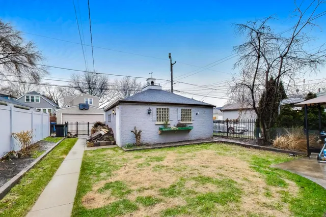 a front view of a house with a yard table and chairs