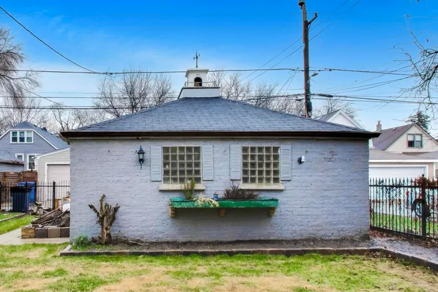 a view of a house with a yard and deck