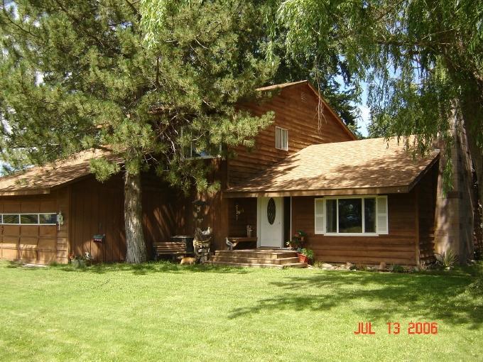 a view of a house with backyard porch and sitting area