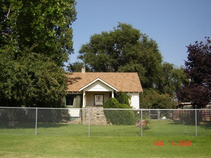 1291 North Track Road Wapato, WA 98951 - Photo 9 of 18 a front view of a house with a garden