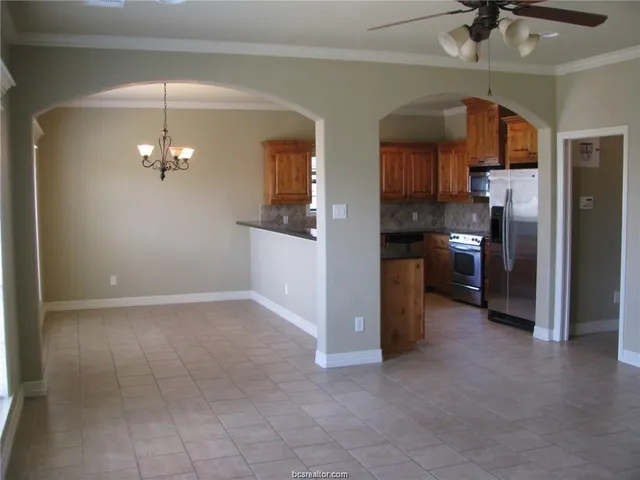 a view of a kitchen with a sink and stainless steel appliances