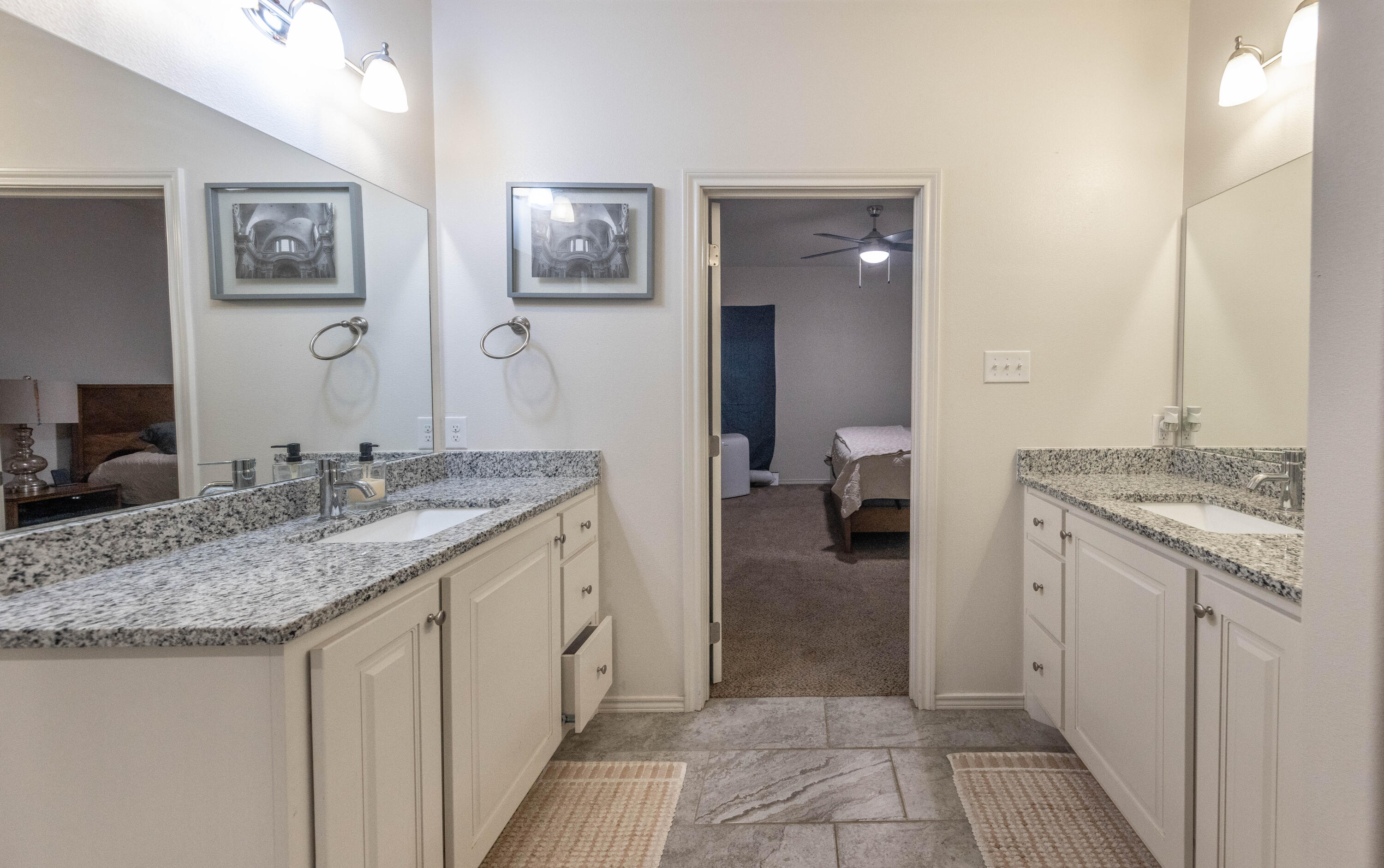 5510 Lehigh Street Lubbock, TX 79416 - Photo 13 of 32 a bathroom with a granite countertop sink and a mirror