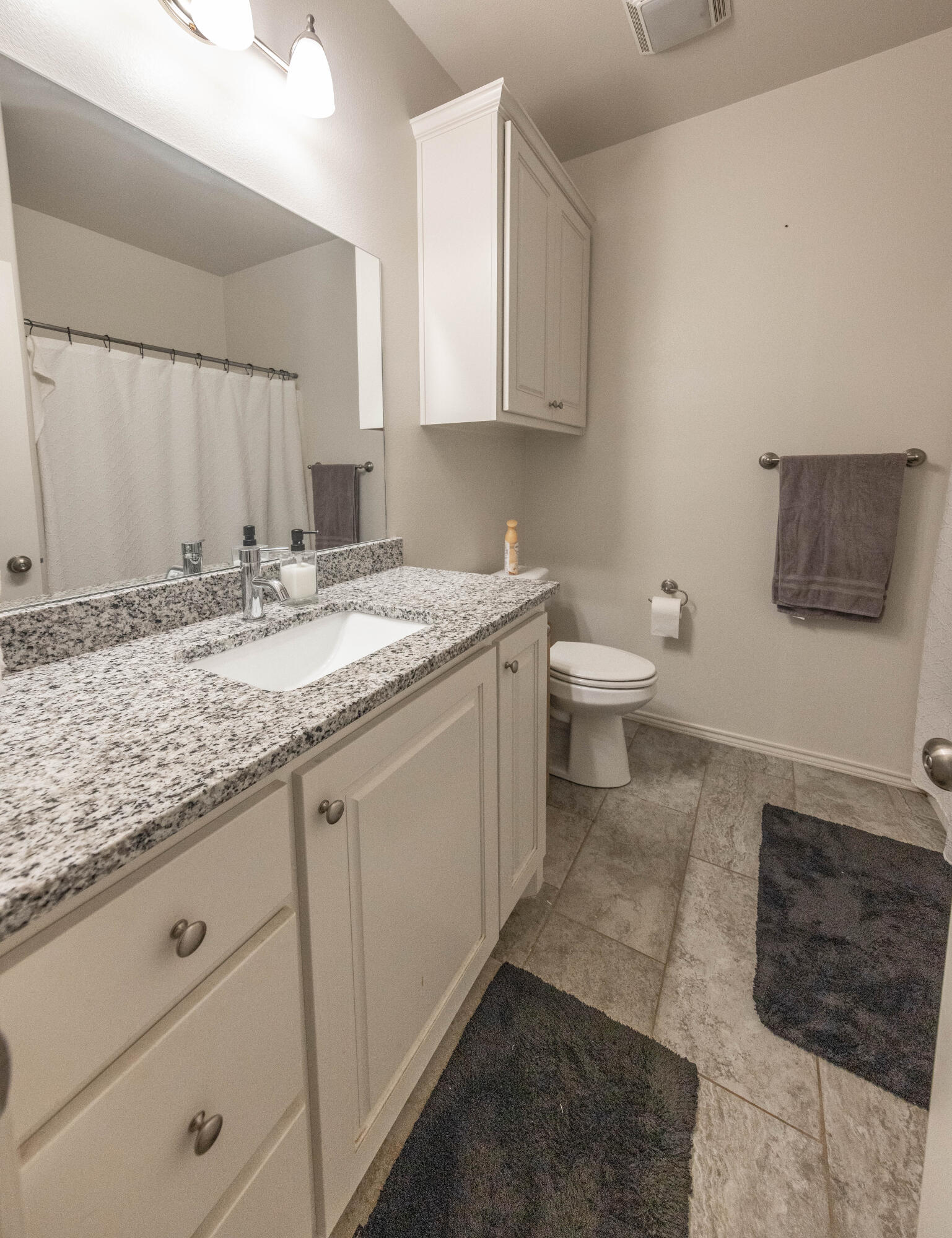 5510 Lehigh Street Lubbock, TX 79416 - Photo 16 of 32 a bathroom with a granite countertop sink and a toilet