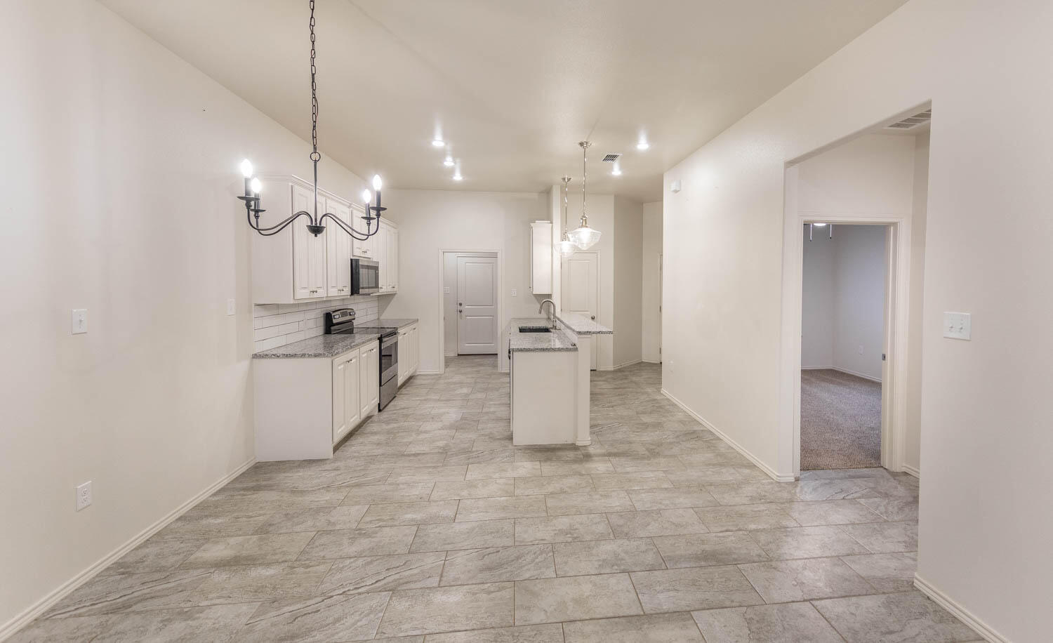 5510 Lehigh Street Lubbock, TX 79416 - Photo 20 of 32 a large kitchen with cabinets and stainless steel appliances