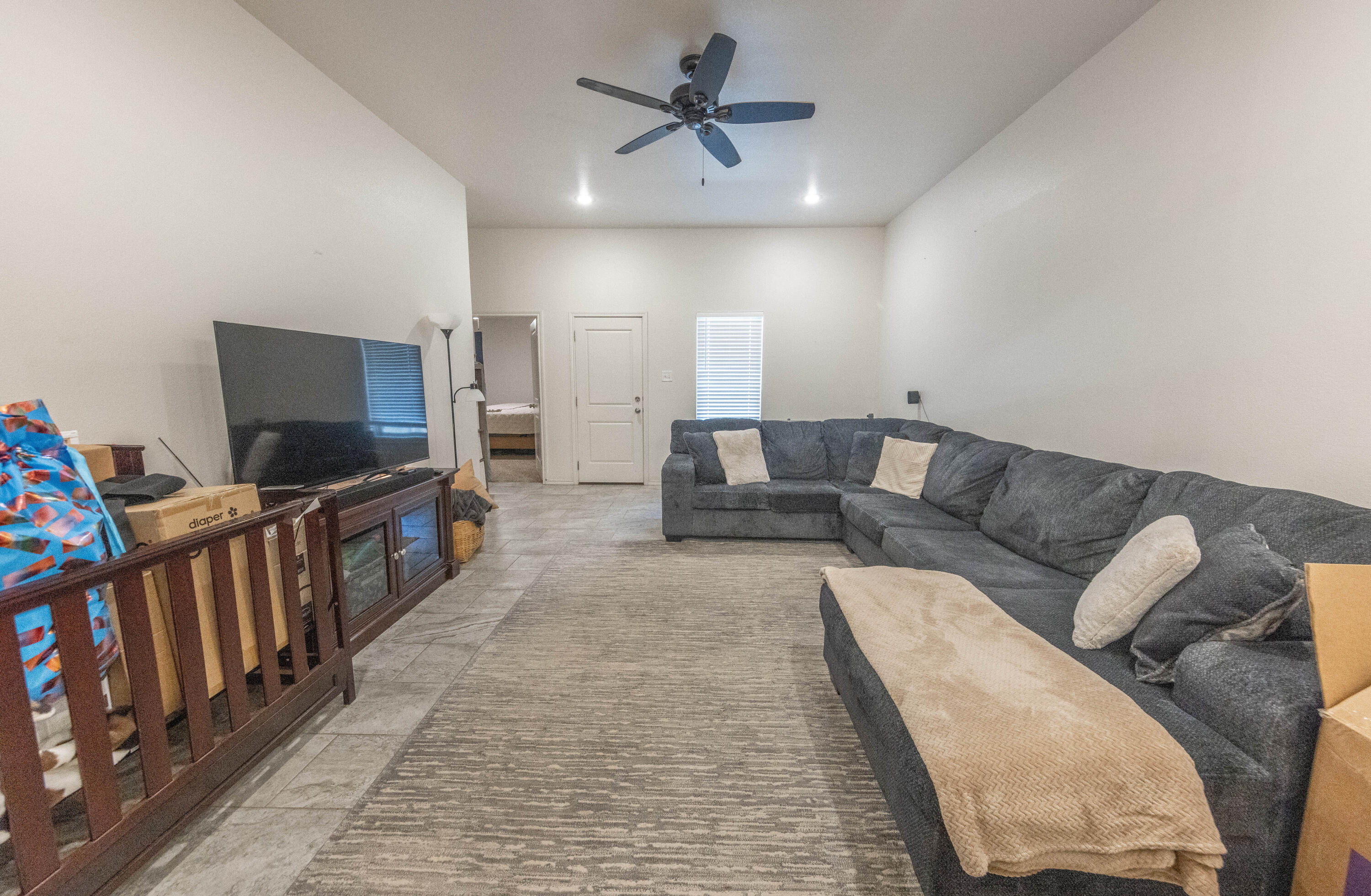 5510 Lehigh Street Lubbock, TX 79416 - Photo 2 of 32 a living room with furniture and a flat screen tv