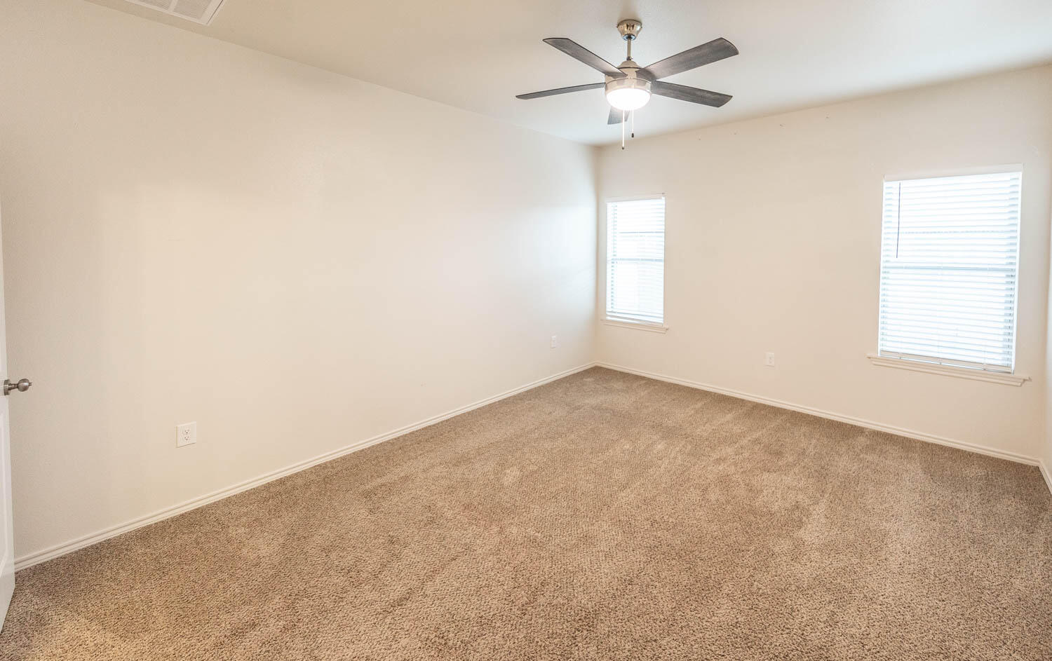 5510 Lehigh Street Lubbock, TX 79416 - Photo 24 of 32 an empty room with a window and a fan