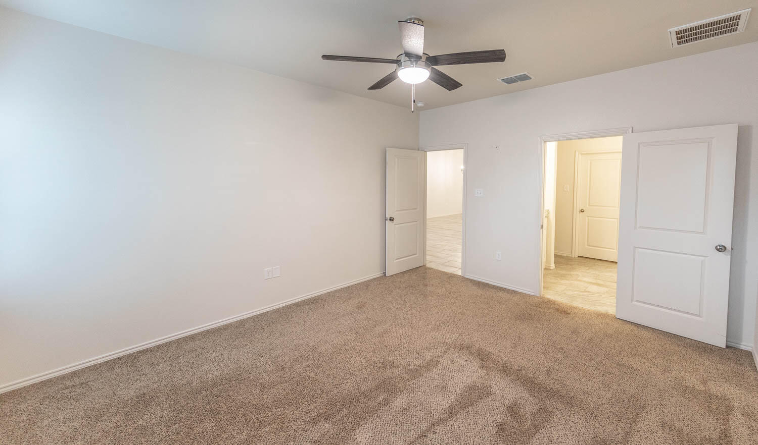 5510 Lehigh Street Lubbock, TX 79416 - Photo 25 of 32 an empty room with a ceiling fan and a window