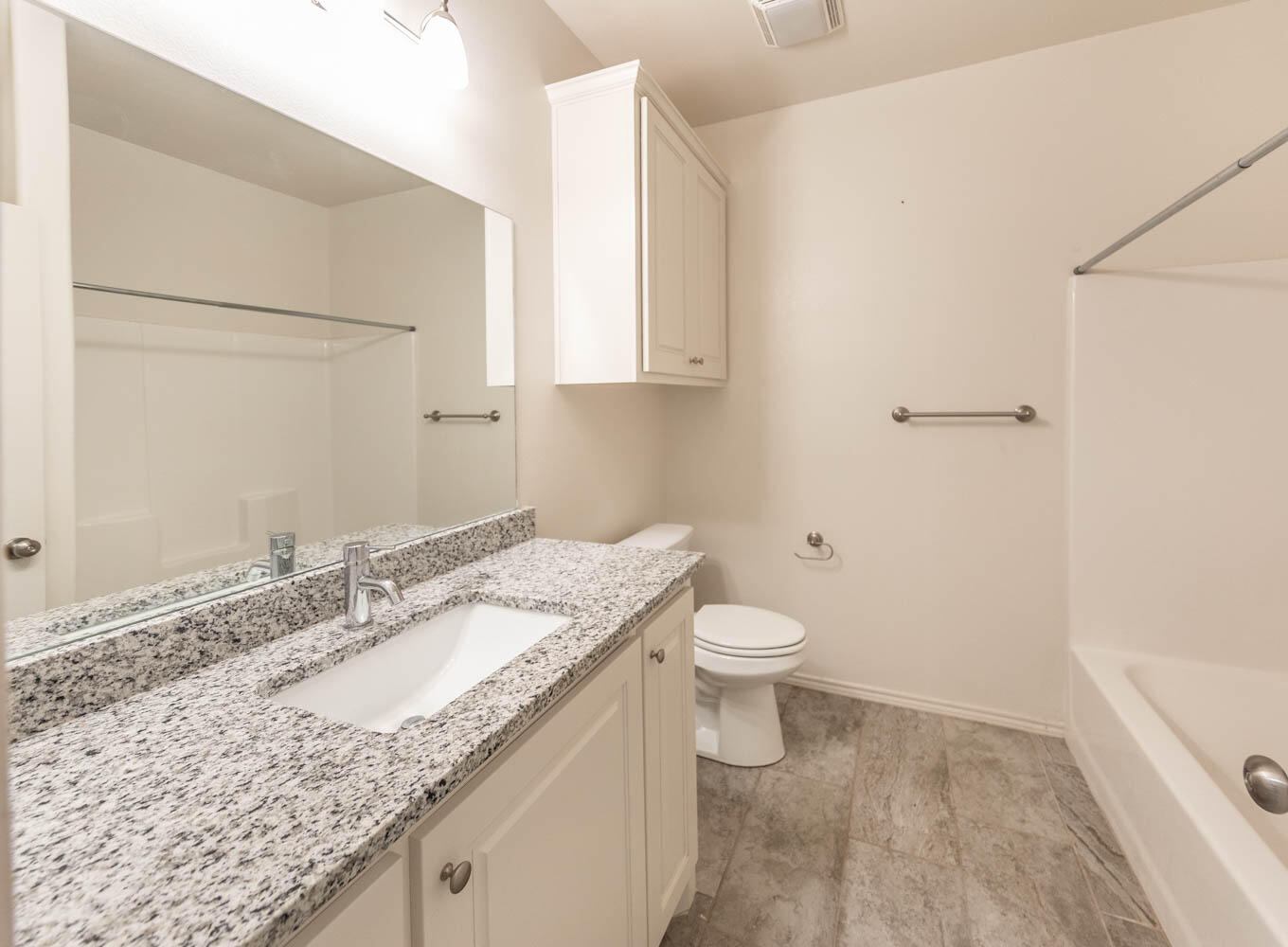 5510 Lehigh Street Lubbock, TX 79416 - Photo 30 of 32 a bathroom with a granite countertop sink and a mirror