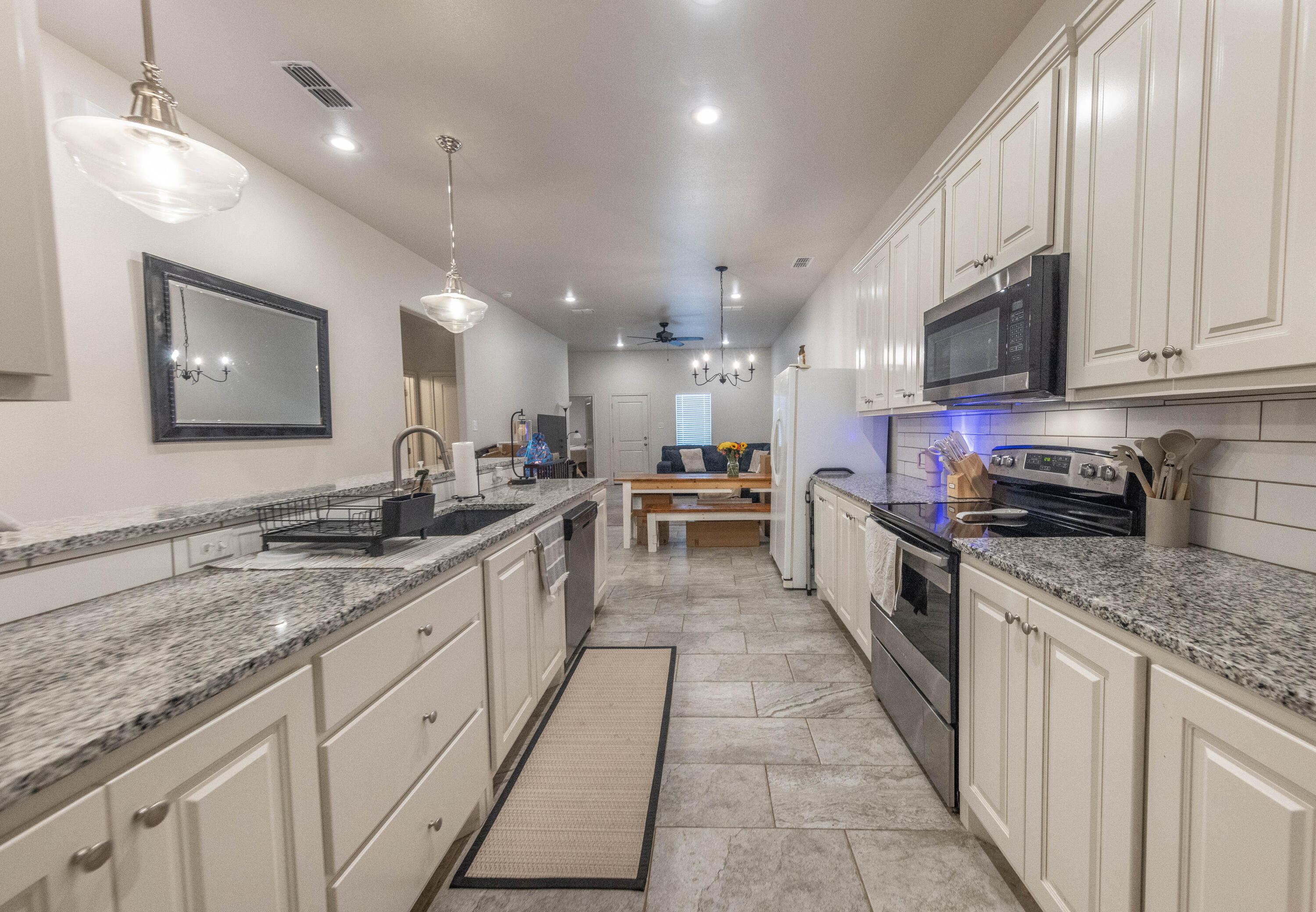 5510 Lehigh Street Lubbock, TX 79416 - Photo 3 of 32 a large kitchen with stainless steel appliances granite countertop a lot of counter space and a sink