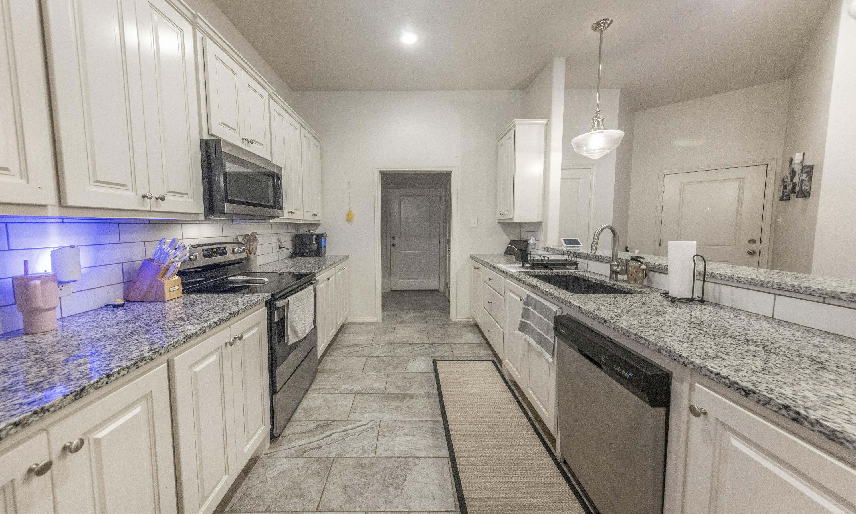 5510 Lehigh Street Lubbock, TX 79416 - Photo 7 of 32 a kitchen with stainless steel appliances granite countertop a sink stove and cabinets