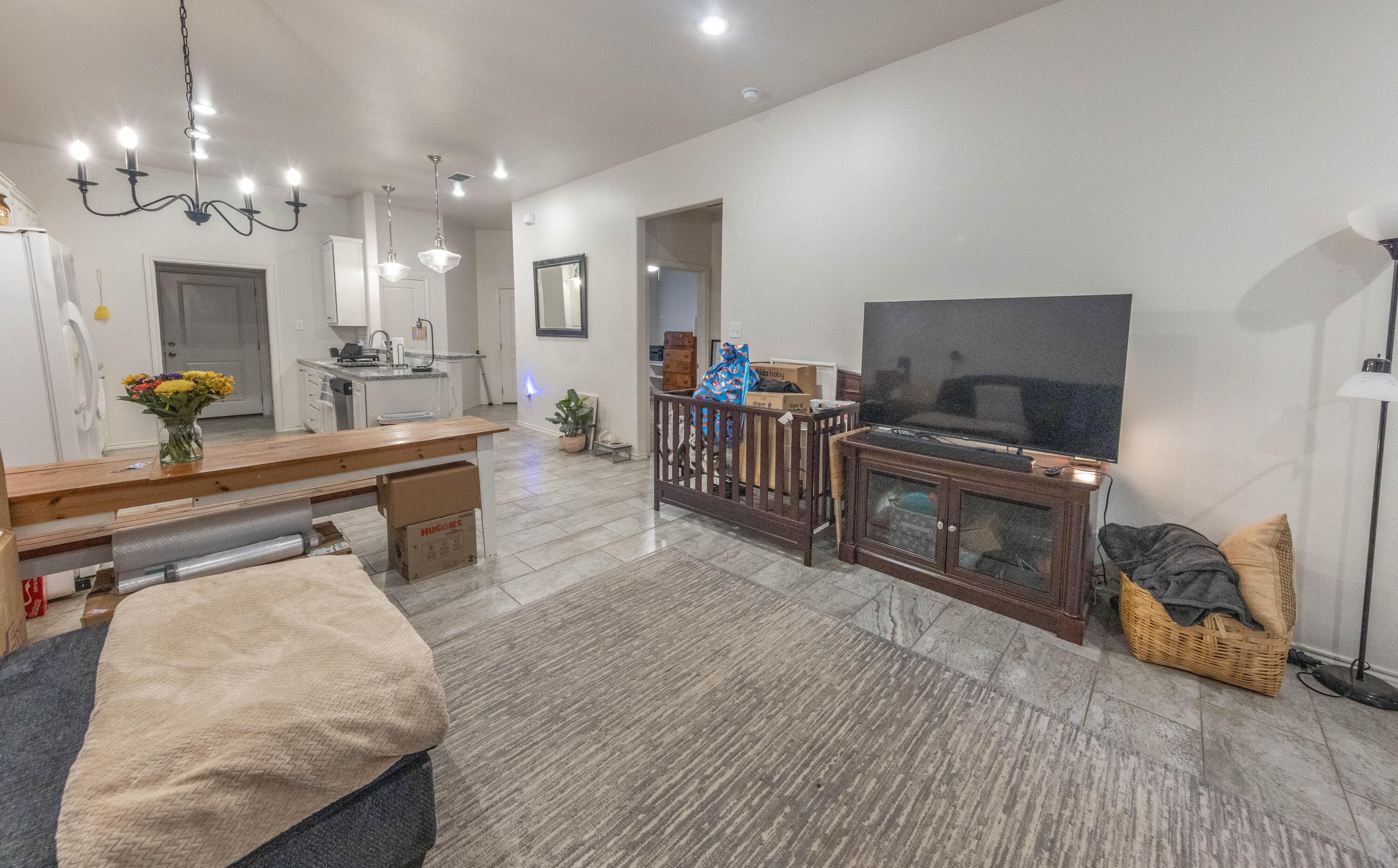 5510 Lehigh Street Lubbock, TX 79416 - Photo 9 of 32 a living room with furniture a flat screen tv and kitchen view