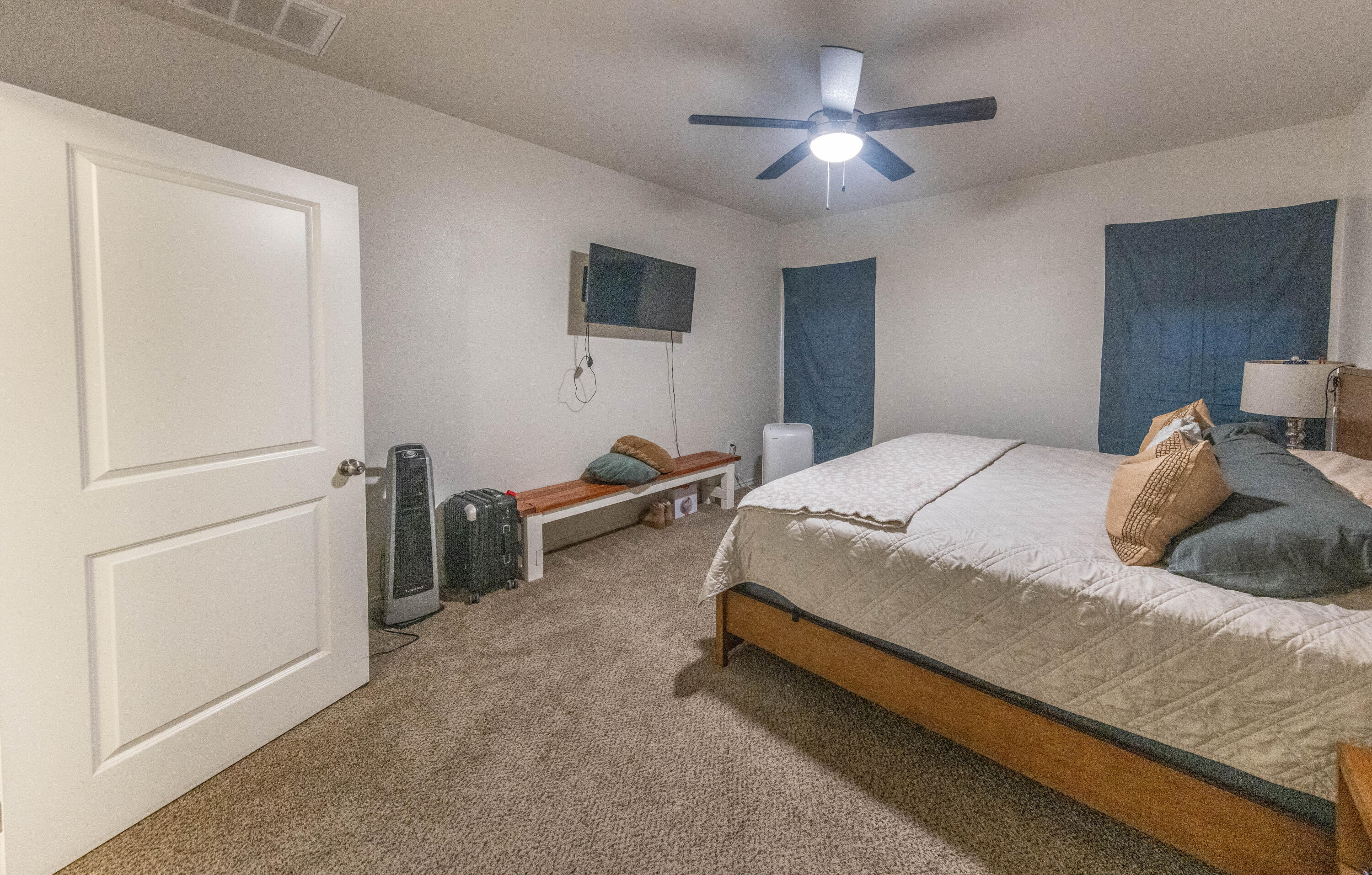5510 Lehigh Street Lubbock, TX 79416 - Photo 10 of 32 a bedroom with a bed and a chandelier