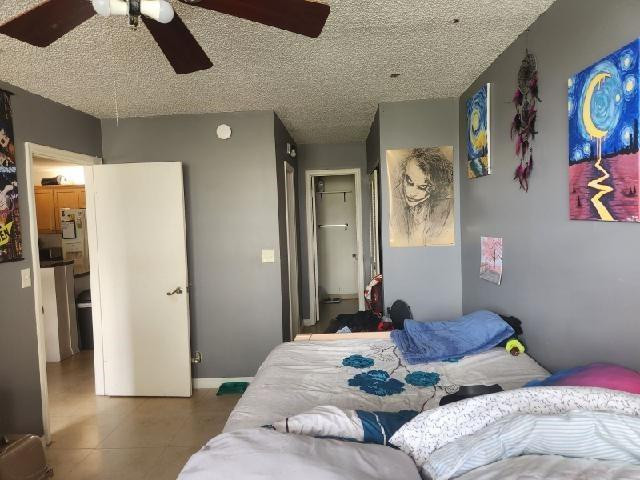 2501 Riverside Drive, Unit 417A Coral Springs, FL 33065 - Photo 7 of 8 a bedroom with a bed and wooden floor