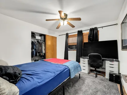 a bedroom with a bed and a chair