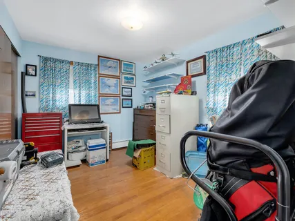 a bedroom with furniture and a book shelf