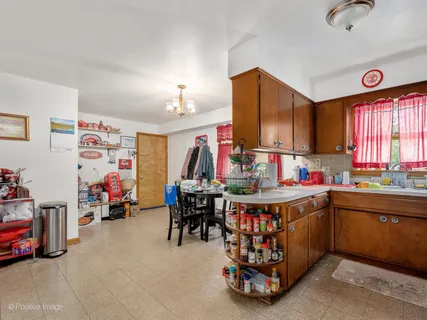 a view of a kitchen with fridge and window