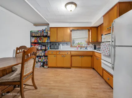 a kitchen with stainless steel appliances a white cabinets and a couch