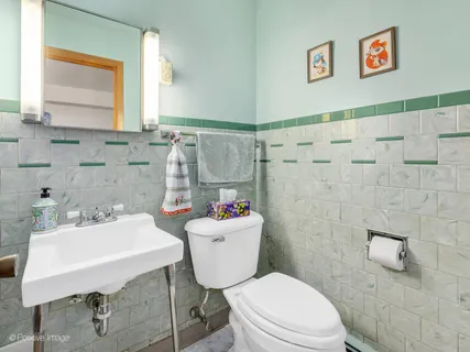 a bathroom with a sink a toilet and shower curtain