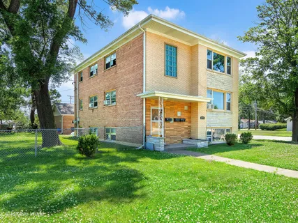 a front view of house with a garden
