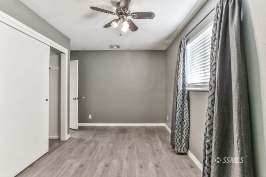 515 South Downs Street Ridgecrest, CA 93555 - Photo 19 of 31 a view of an empty room with wooden floor and a window