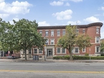 514 Harvard Street, Unit 2D Brookline, MA 02446 - Photo 10 of 11 a view of a big building next to a road