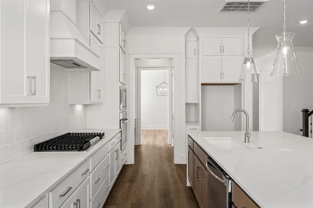 a spacious en suite bathroom with a sink and a large mirror