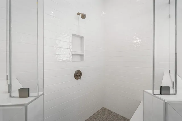 a bathroom with a double vanity sink mirror and