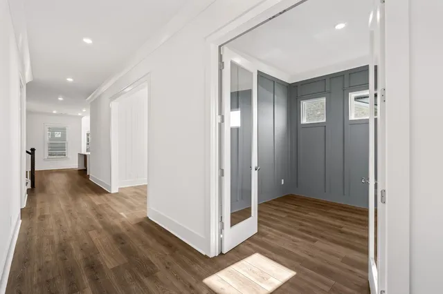 a view of a hallway with wooden floor
